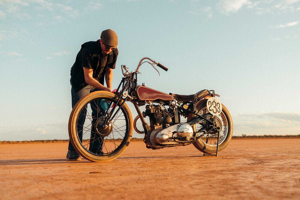 man checking motorcycle tires