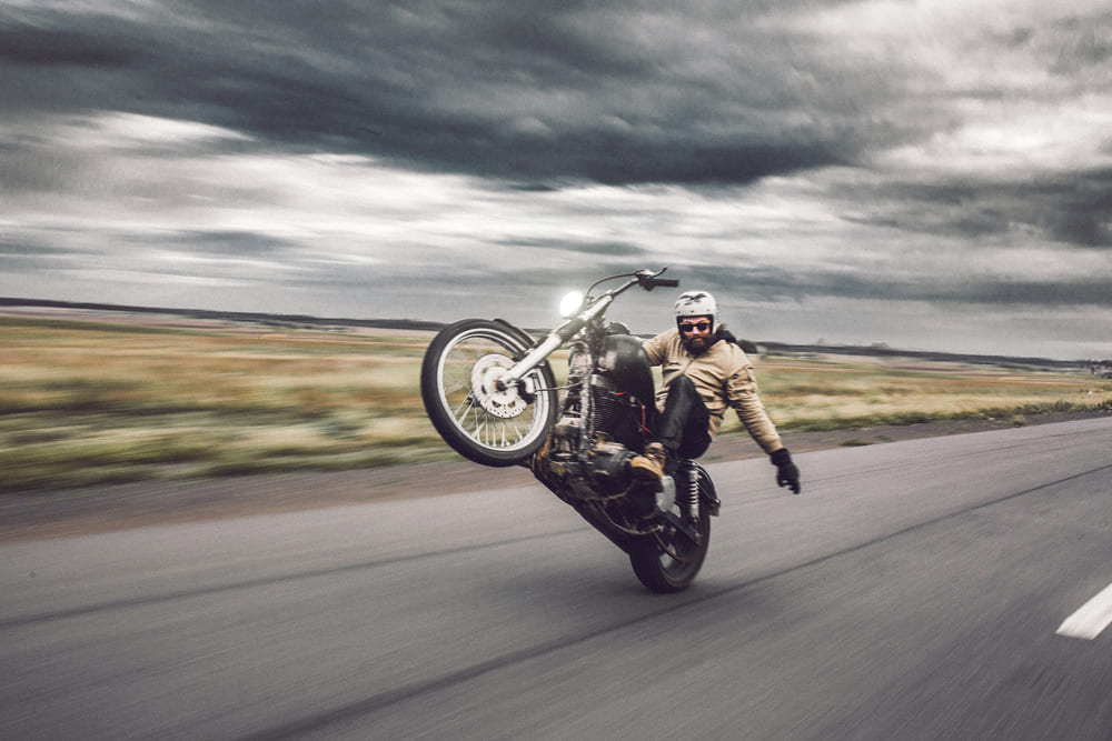 man riding his motorbike on highway