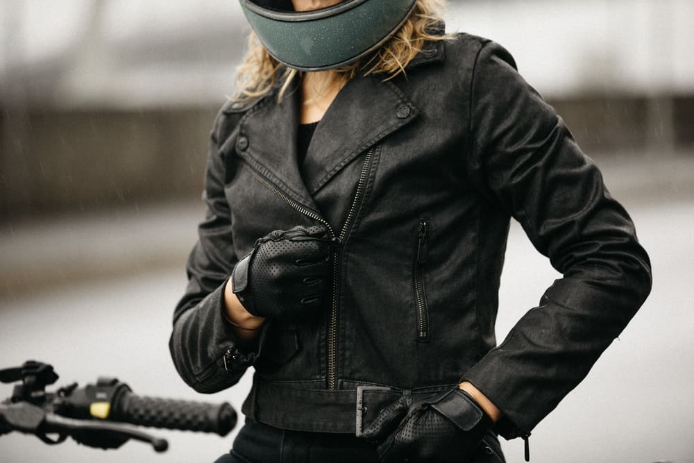 girl zipping up leather jacket